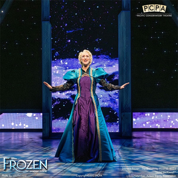 A performer in a blue and purple gown stands center stage with arms open, singing, in a scene from Disney’s Frozen: The Broadway Musical. Enjoy icy, magical scenery and discover Special Offers at The Landsby. The PCPA logo is in the top right corner.